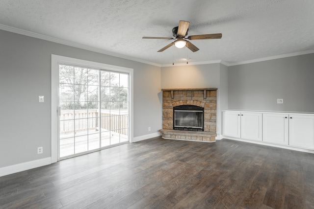 unfurnished living room featuring ceiling fan, a stone fireplace, a textured ceiling, and crown molding