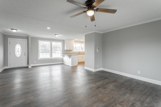 unfurnished living room with ceiling fan, crown molding, and a textured ceiling