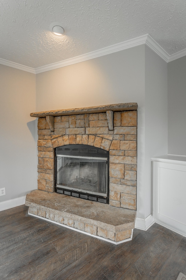 details featuring a fireplace, wood-type flooring, a textured ceiling, and crown molding