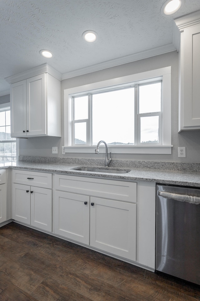 kitchen featuring white cabinetry, dishwasher, sink, dark wood-type flooring, and a textured ceiling