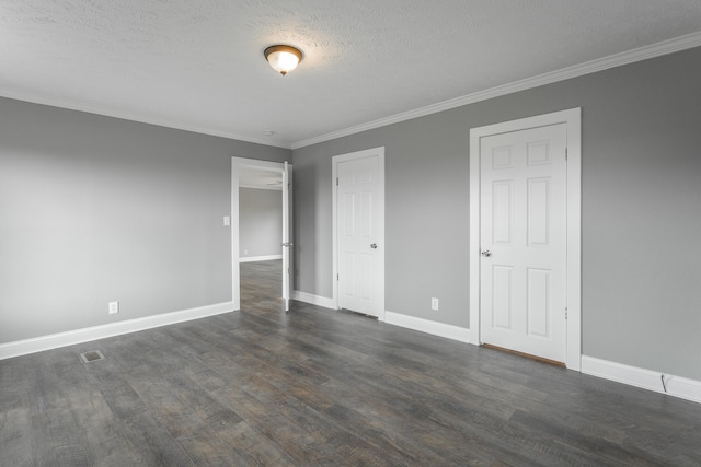 unfurnished bedroom with dark hardwood / wood-style flooring, a textured ceiling, and ornamental molding