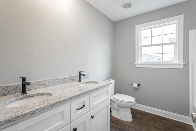 bathroom featuring hardwood / wood-style flooring, vanity, and toilet