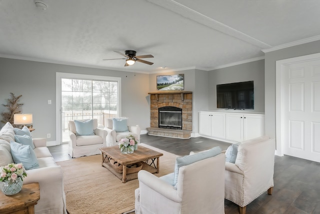 living room featuring a stone fireplace, ceiling fan, crown molding, and wood-type flooring