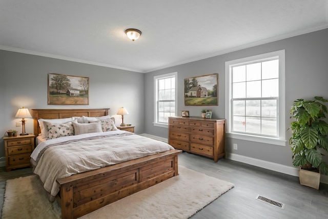 bedroom featuring light wood-type flooring and ornamental molding