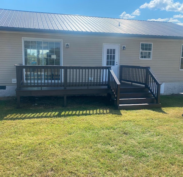 back of house with a lawn and a wooden deck