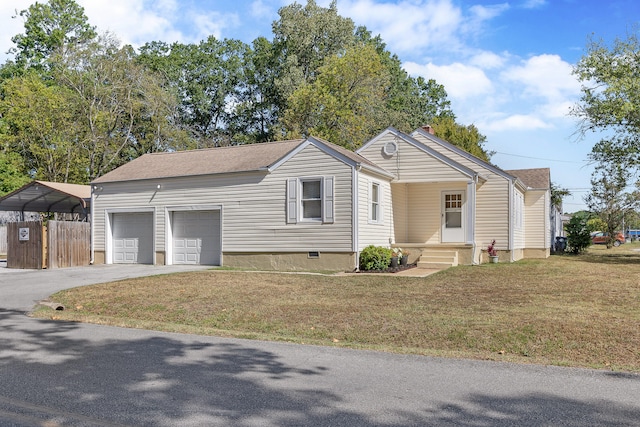 view of front of house with a front yard, a garage, and a carport