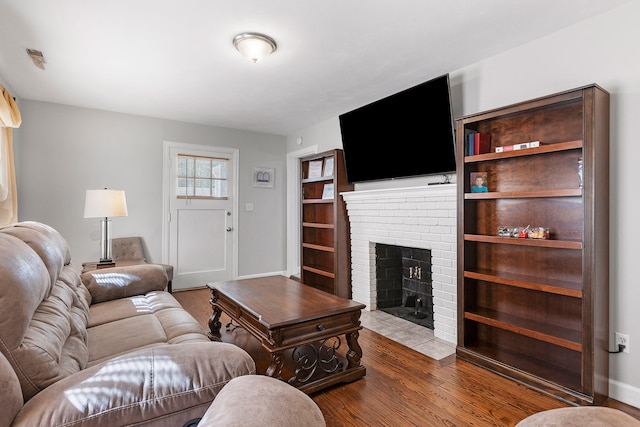 living room with a fireplace and dark hardwood / wood-style floors