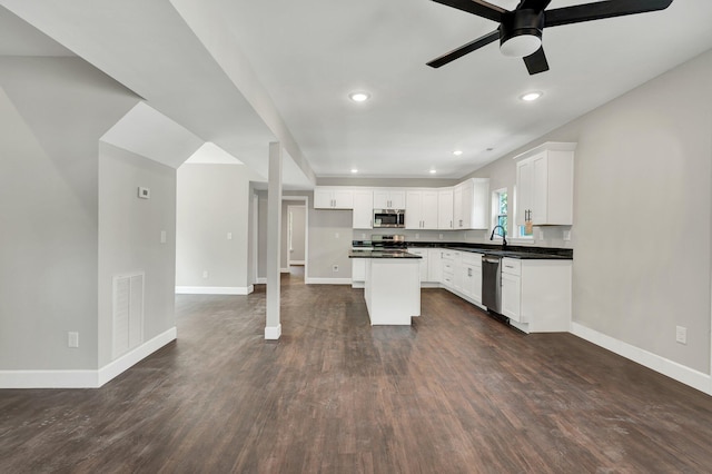 kitchen featuring white cabinetry, a kitchen island, stainless steel appliances, ceiling fan, and dark hardwood / wood-style floors