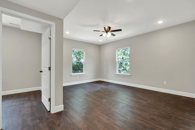 empty room featuring ceiling fan and dark hardwood / wood-style floors