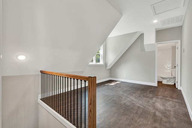 additional living space with lofted ceiling and dark carpet