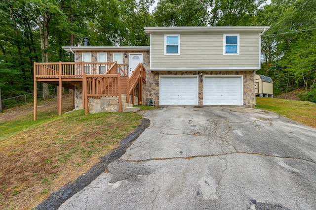 view of front facade featuring a wooden deck and a garage