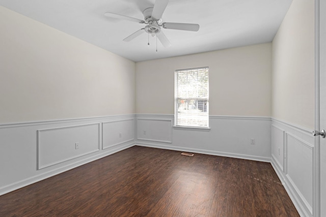 unfurnished room with ceiling fan and dark wood-type flooring