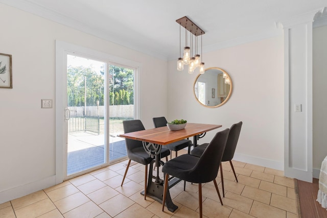 dining area featuring an inviting chandelier, light wood-type flooring, crown molding, and ornate columns