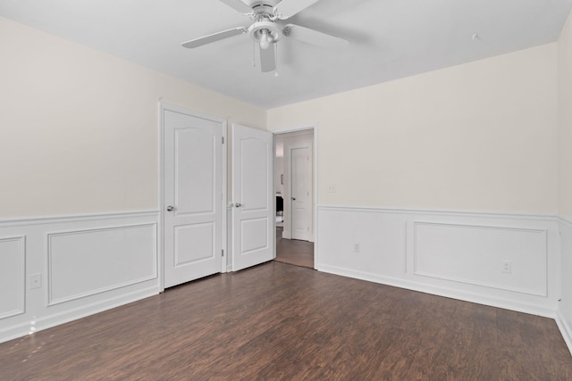 unfurnished bedroom featuring ceiling fan and dark hardwood / wood-style flooring