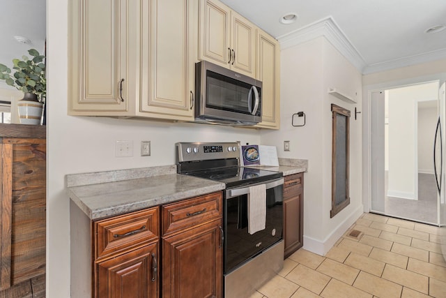 kitchen featuring cream cabinetry, ornamental molding, light stone countertops, and stainless steel appliances