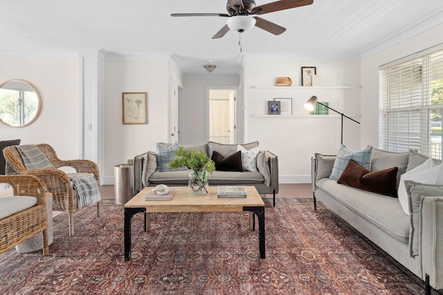 living room with ornamental molding and ceiling fan