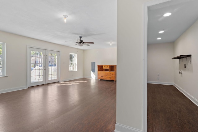 unfurnished living room featuring french doors, ceiling fan, and dark wood-type flooring