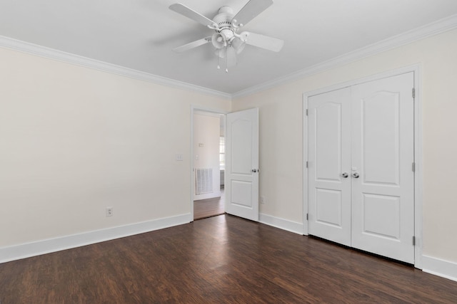 unfurnished bedroom featuring ornamental molding, a closet, ceiling fan, and dark hardwood / wood-style flooring