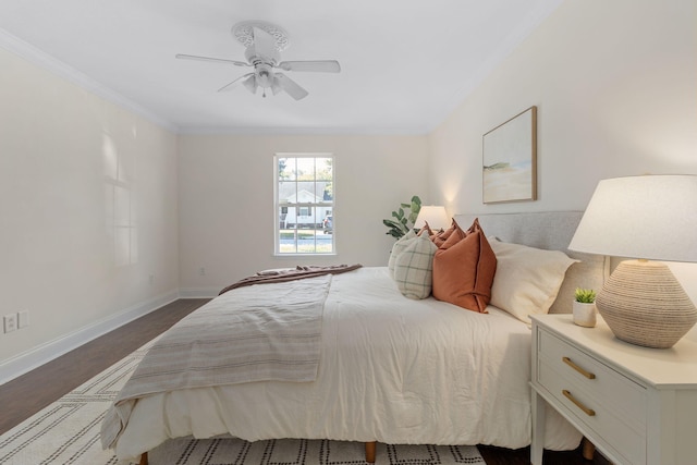 bedroom with ceiling fan, crown molding, and dark hardwood / wood-style flooring