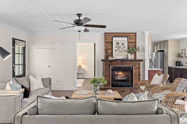 living room featuring ceiling fan, hardwood / wood-style floors, and ornamental molding