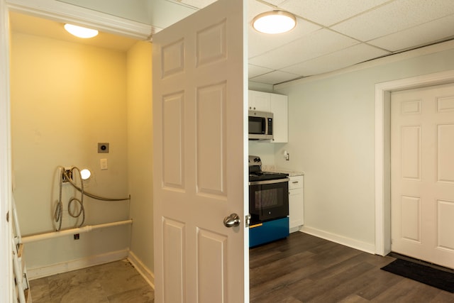 laundry room with baseboards, dark wood-type flooring, and laundry area