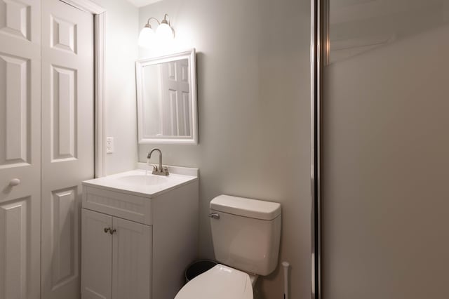 half bathroom with toilet and vanity