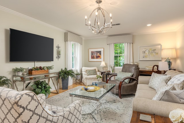 living room with ornamental molding, a chandelier, and hardwood / wood-style flooring