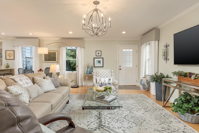 living room featuring ornamental molding, light hardwood / wood-style floors, and an inviting chandelier