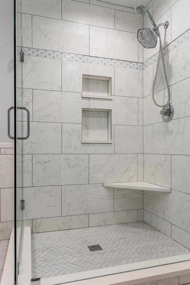 bathroom featuring a shower with door