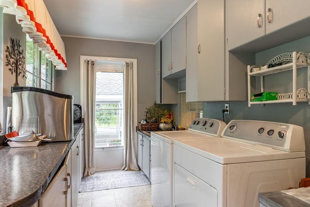 washroom with washer and clothes dryer, ornamental molding, light tile patterned floors, and cabinets