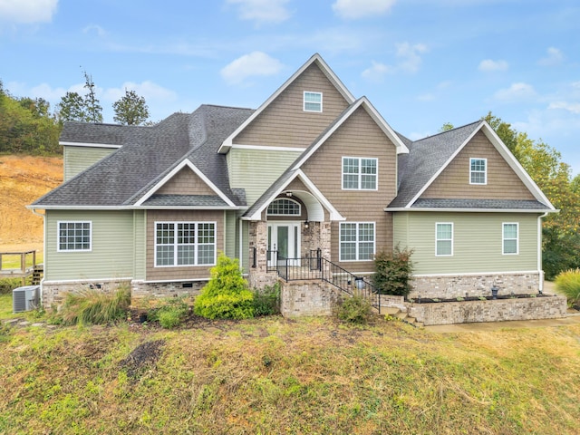 craftsman inspired home with cooling unit and a front lawn