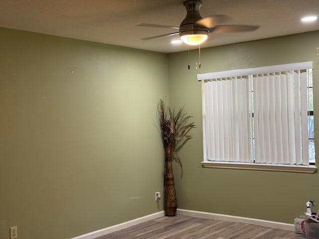 spare room with ceiling fan and wood-type flooring