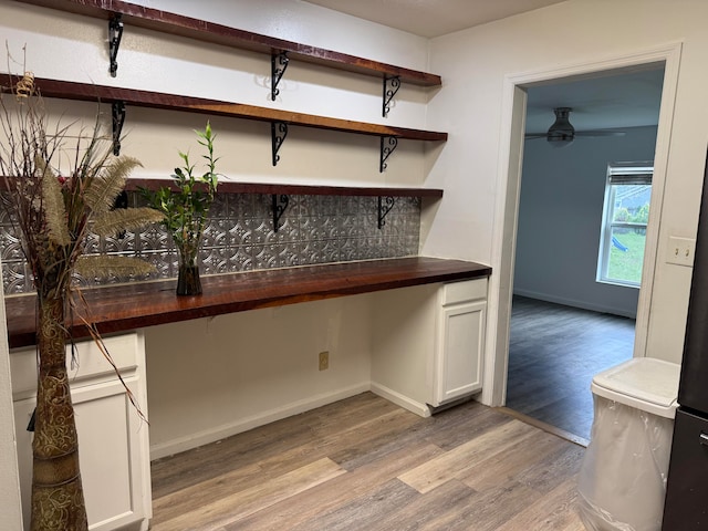 bar featuring white cabinets, ceiling fan, light hardwood / wood-style floors, and wooden counters