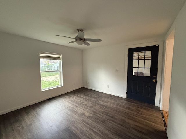 foyer featuring ceiling fan and dark wood-type flooring