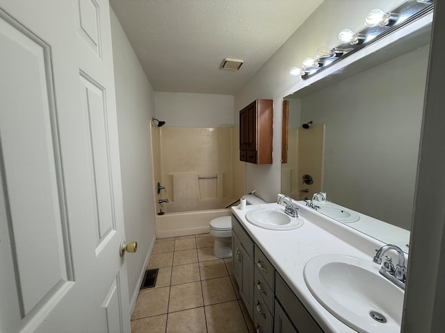 full bathroom featuring tile patterned floors, bathtub / shower combination, a textured ceiling, vanity, and toilet