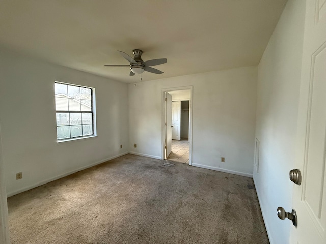 spare room with light colored carpet and ceiling fan