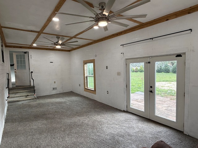 unfurnished living room featuring a wealth of natural light, french doors, carpet floors, and ornamental molding