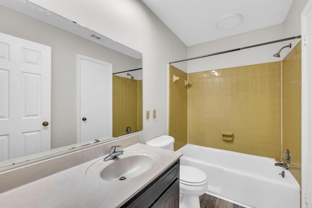 full bathroom featuring vanity, tiled shower / bath combo, wood-type flooring, and toilet