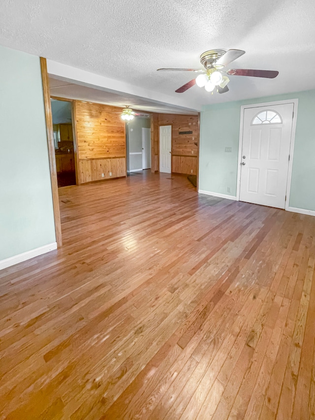 unfurnished living room featuring ceiling fan and light wood-type flooring