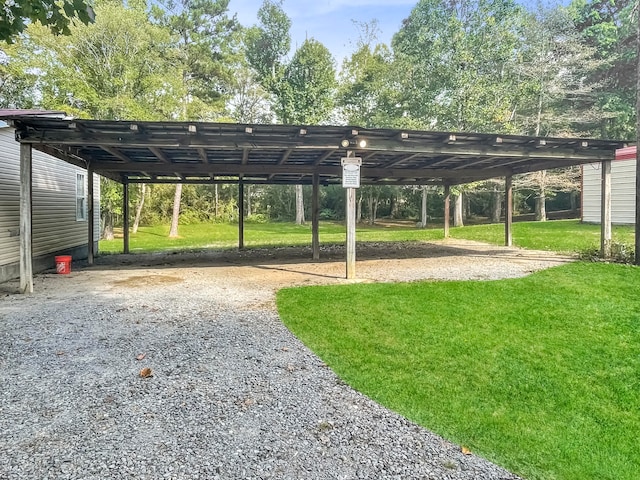 view of vehicle parking featuring a carport and a yard