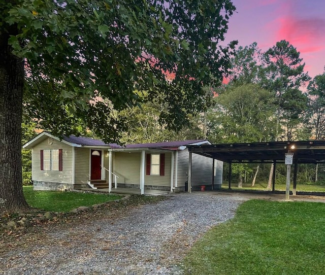 view of front of house with a yard and a carport