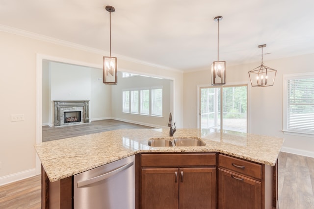 kitchen featuring light hardwood / wood-style floors, dishwasher, a kitchen island with sink, and sink