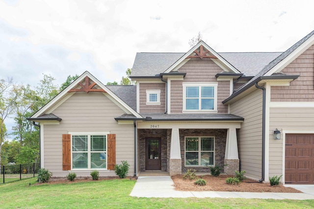 craftsman house featuring a front yard and a porch