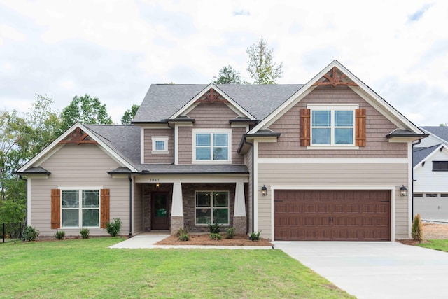 craftsman house featuring a front yard and a garage