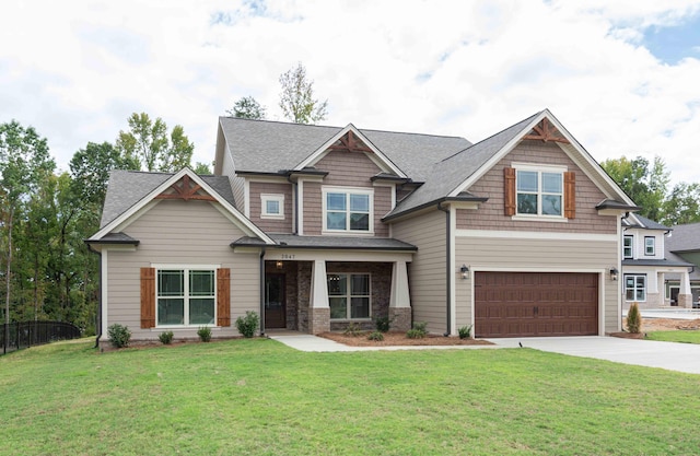 craftsman-style house with a garage and a front lawn