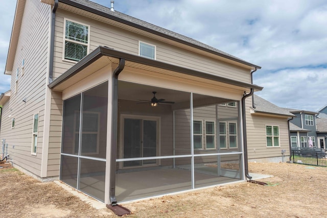 rear view of house featuring a sunroom, a patio area, and ceiling fan