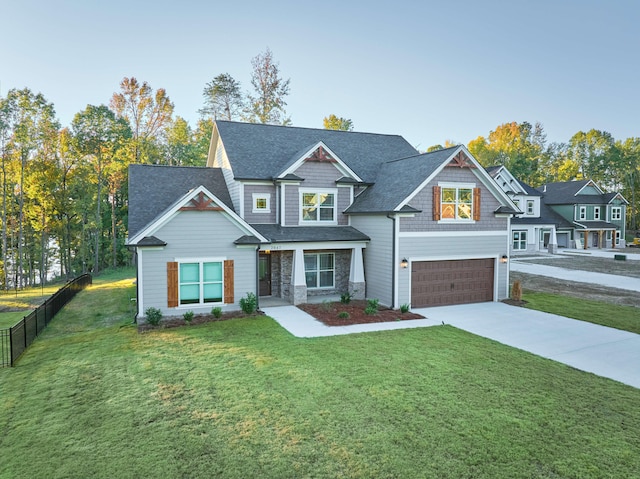 craftsman inspired home with a front yard and a garage