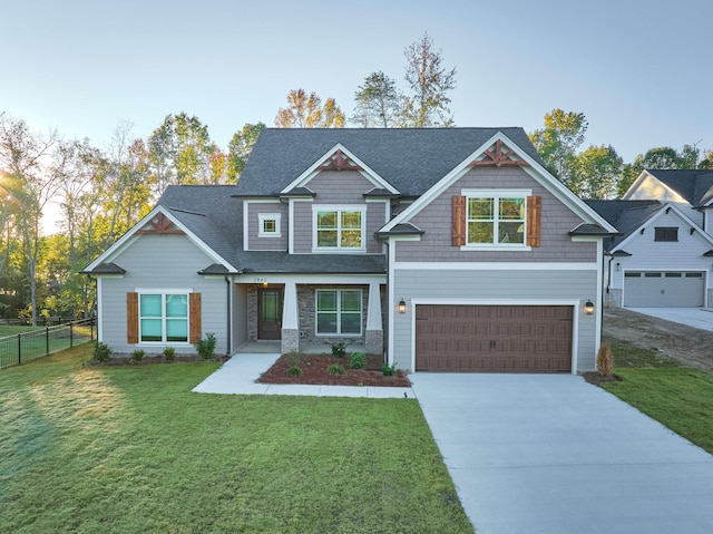 craftsman-style house featuring a front lawn and a garage