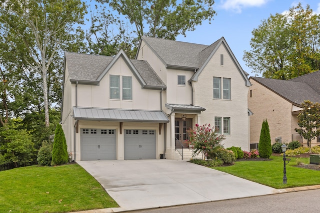 view of front of house featuring a garage and a front lawn