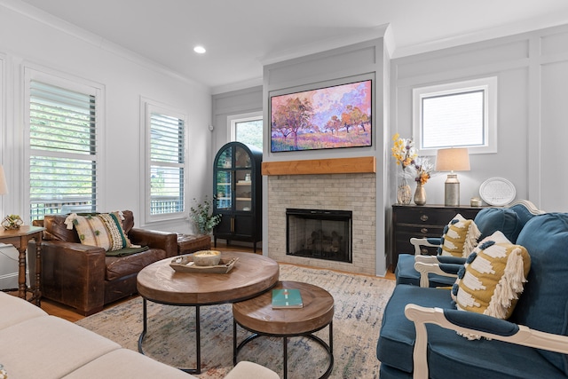 living room featuring a brick fireplace and ornamental molding